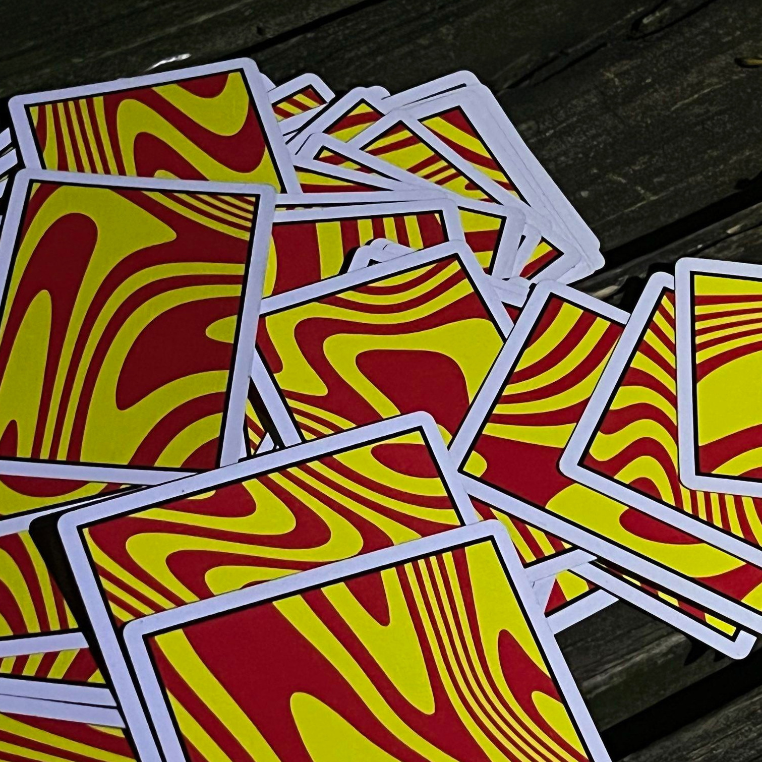 cards messily spread on wooden bench